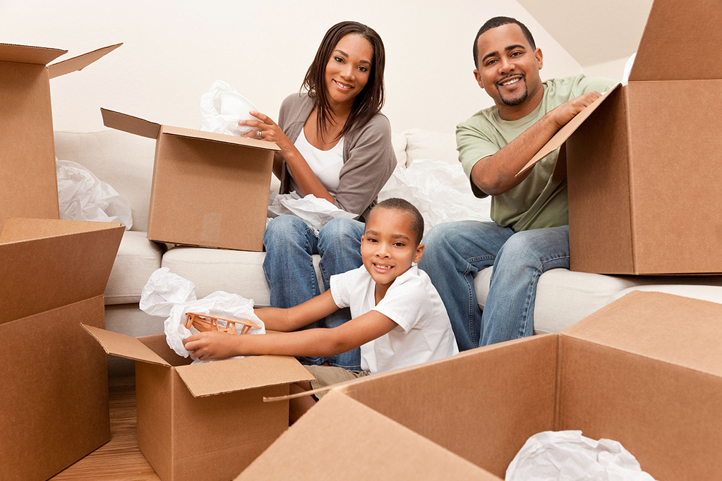 American family unpacking boxes